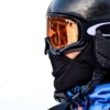 macro photo of person in black goggles and black face mask